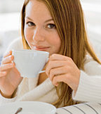 Young woman dringing a cup of hot herbal tea. - Copyright – Stock Photo / Register Mark