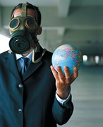 Man wearing gas mask holds the Earth in his hand. - Copyright – Stock Photo / Register Mark