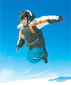 A boy jumps over ridge of snow. - Copyright – Stock Photo / Register Mark