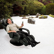 Man sitting in massage chair on zen sand garden. - Copyright – Stock Photo / Register Mark